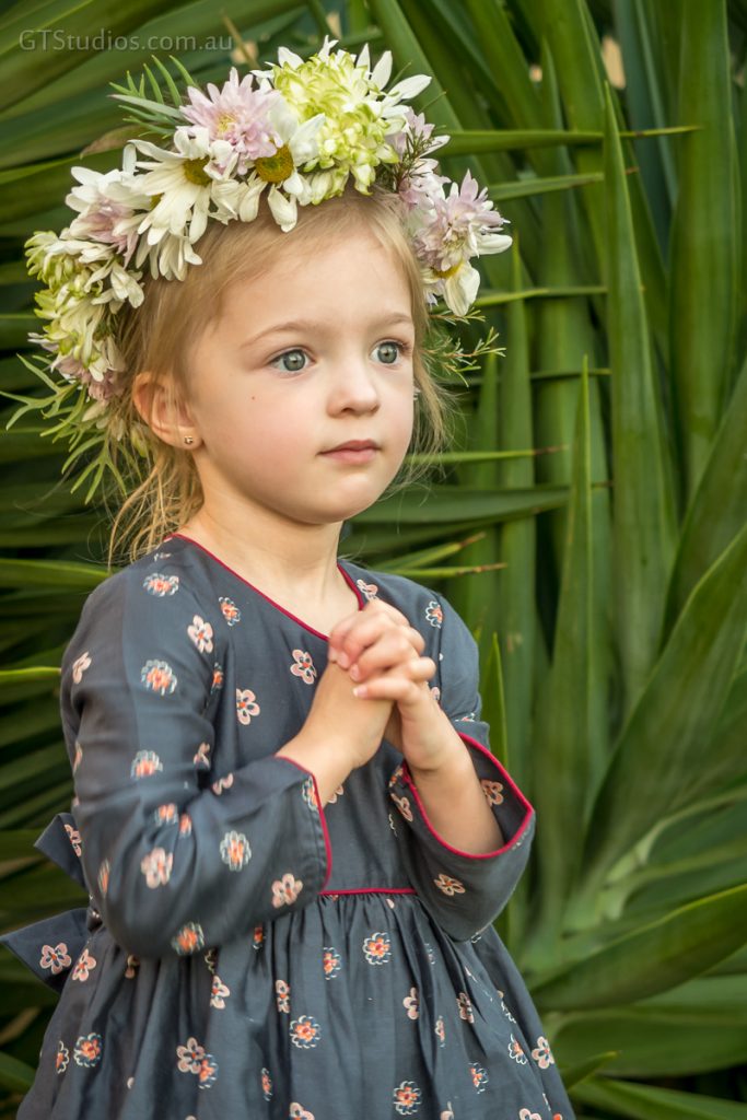 Girl standing in pretty dress with flower crown