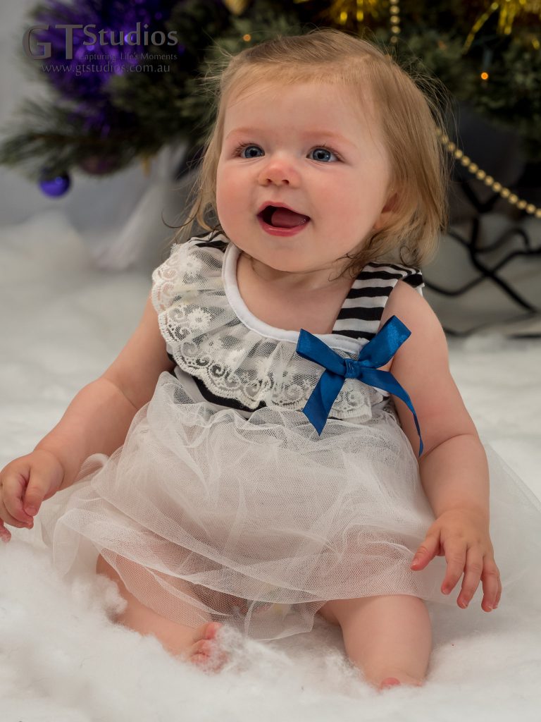 Baby in front of Christmas tree